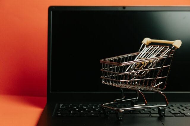 miniature-shopping-cart-on-a-laptop-keyboard
